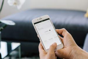 Zeel gets more signups by offering swag through their mobile app, shown on a phone.
