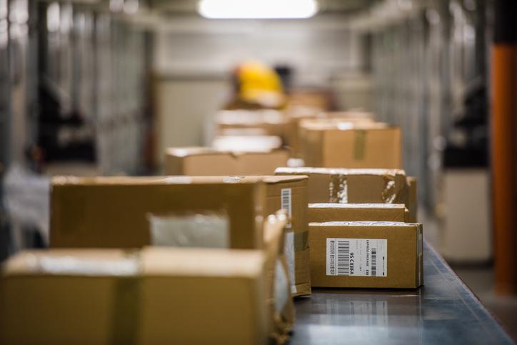 Boxes on conveyer belt Packed boxes being sent out by a basic merchandise fulfllment company