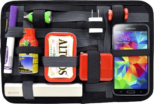 cocoon tech organizer swag item with mints, pens, and phone secured